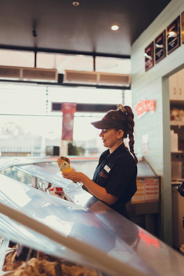 A team member checking a menu item behind the counter